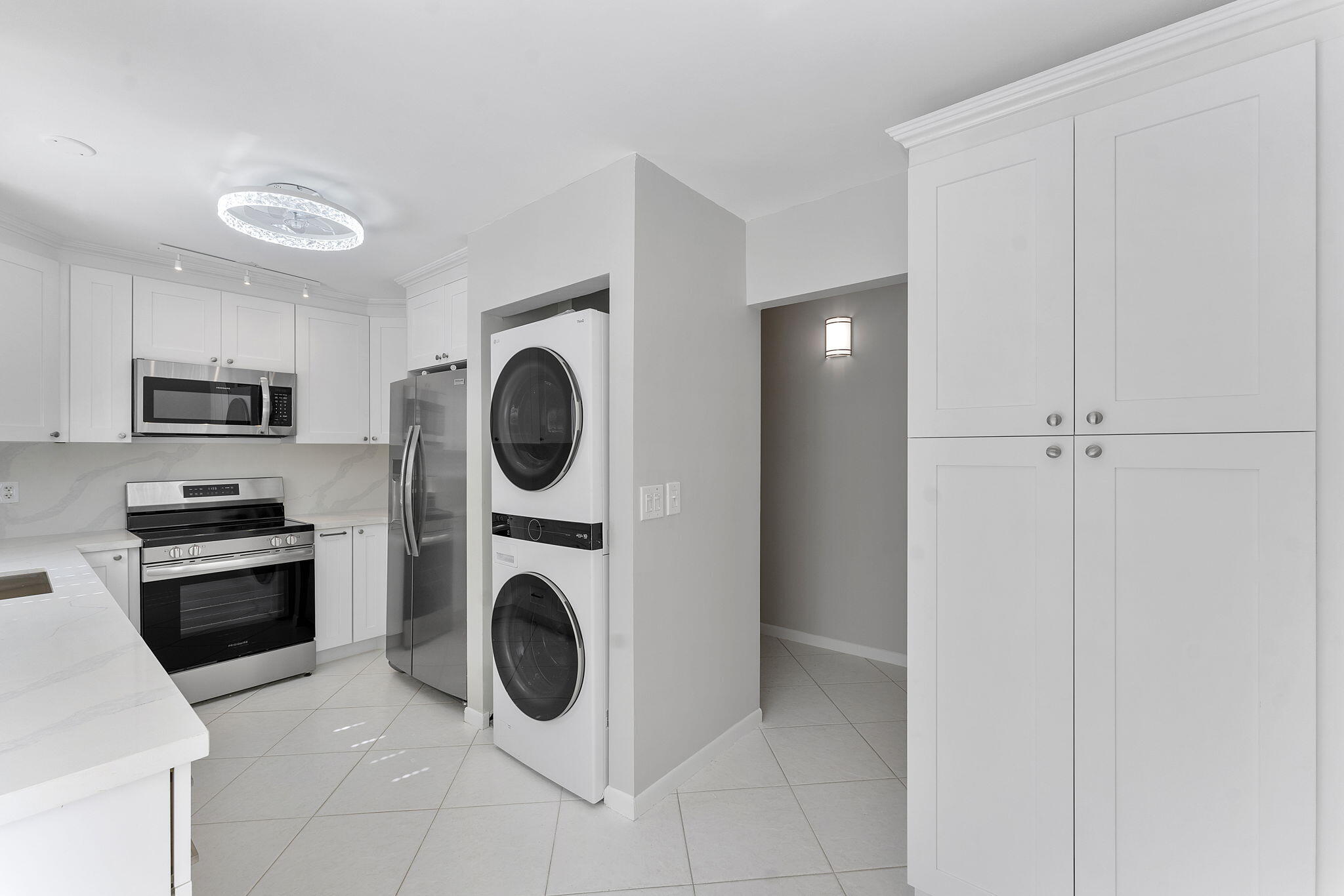 159 Northwest 70th Street, Unit 603 Boca Raton, FL 33487 - Photo 9 of 35 a view of kitchen and washer and dryer