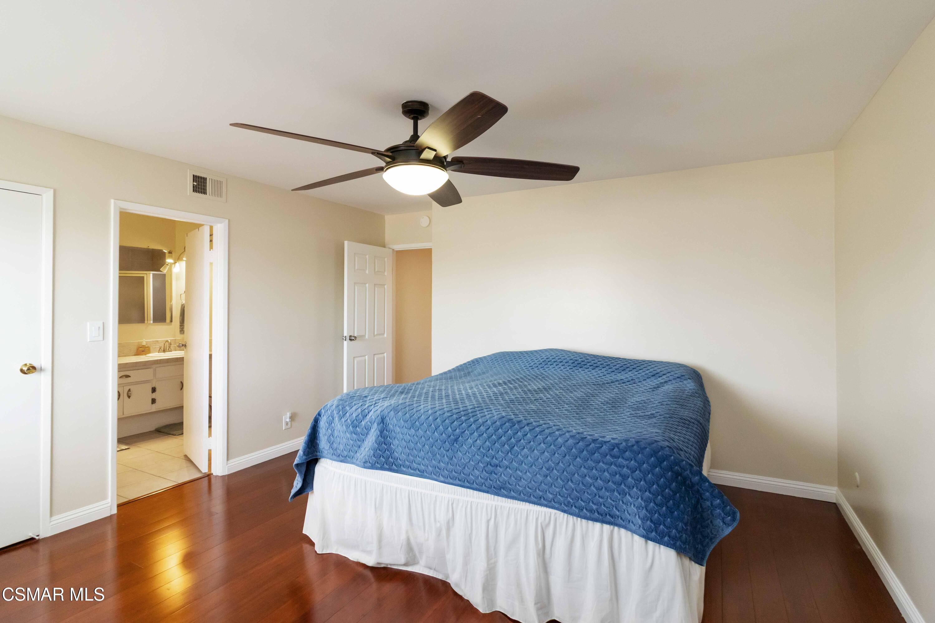 705 Wishard Avenue Simi Valley, CA 93065 - Photo 23 of 50 a bedroom with a bed and wooden floor