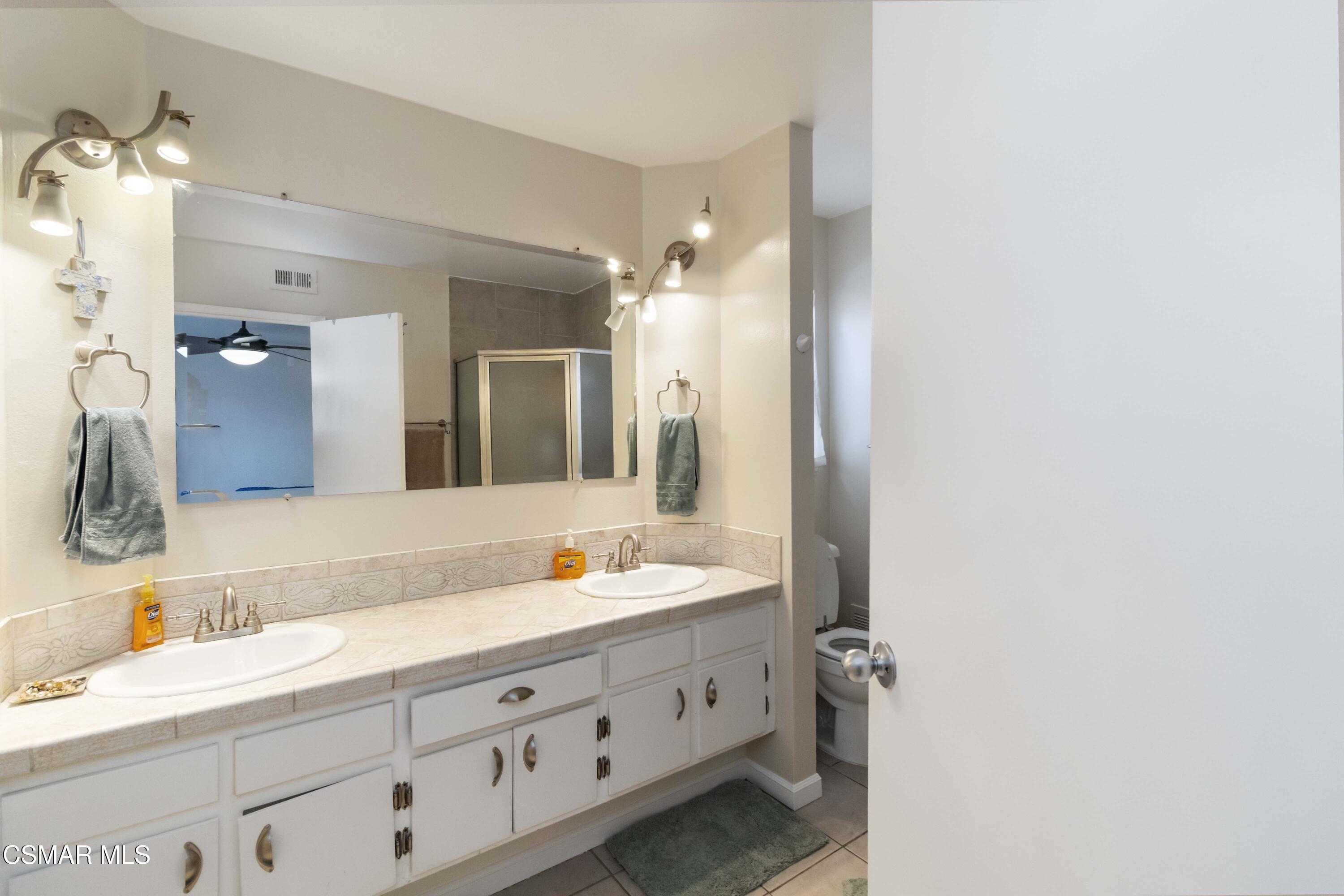 705 Wishard Avenue Simi Valley, CA 93065 - Photo 24 of 50 a bathroom with a double vanity sink and mirror