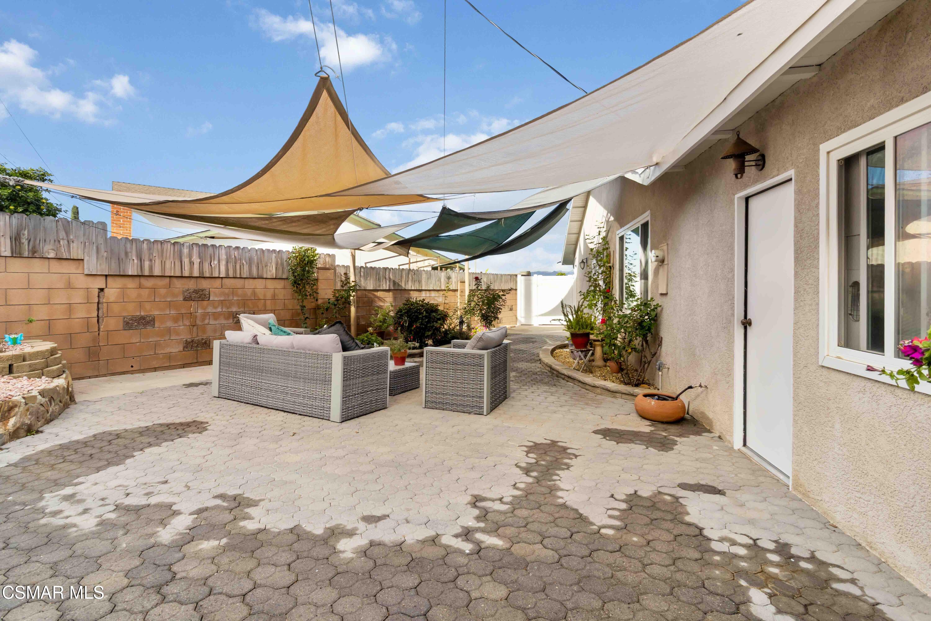 705 Wishard Avenue Simi Valley, CA 93065 - Photo 38 of 50 a view of a patio with table and chairs potted plants