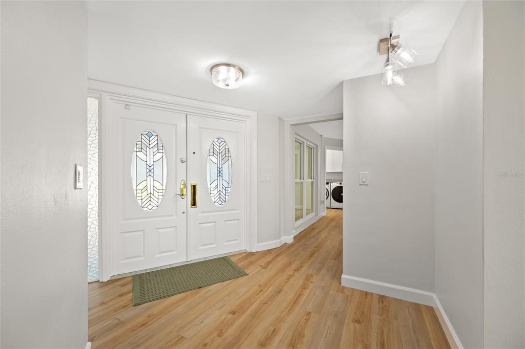 656 Mehlenbacher Road Belleair, FL 33756 - Photo 5 of 49 a view of a hallway view with wooden floor and staircase