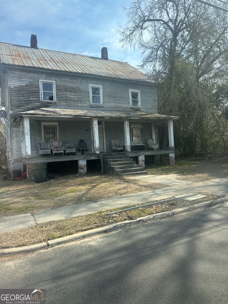 a view of a house with a barbeque grill and a fireplace