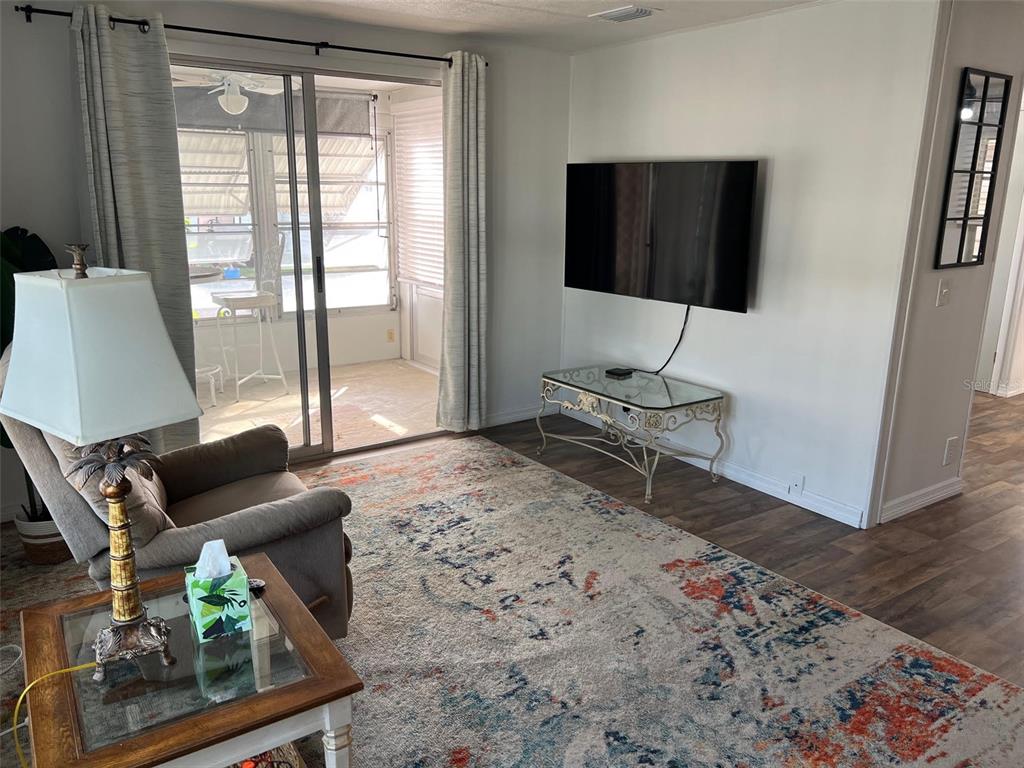 576 Queen Palm Largo, FL 33778 - Photo 13 of 33 a living room with furniture and a flat screen tv