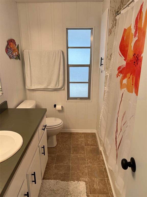 576 Queen Palm Largo, FL 33778 - Photo 17 of 33 a bathroom with a granite countertop sink and a mirror
