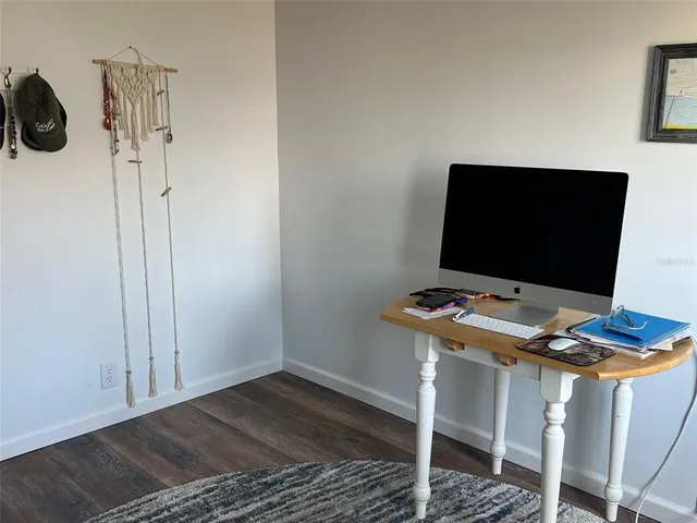 a large bed sitting in a bedroom next to a window and a chair