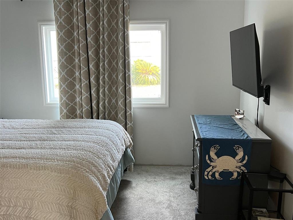 576 Queen Palm Largo, FL 33778 - Photo 25 of 33 a bedroom with a bed and a flat screen tv