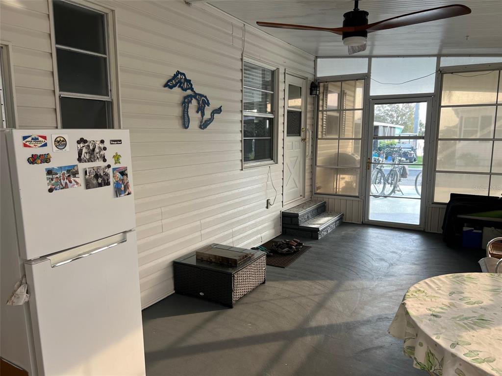 576 Queen Palm Largo, FL 33778 - Photo 32 of 33 a hallway with a couch and chandelier