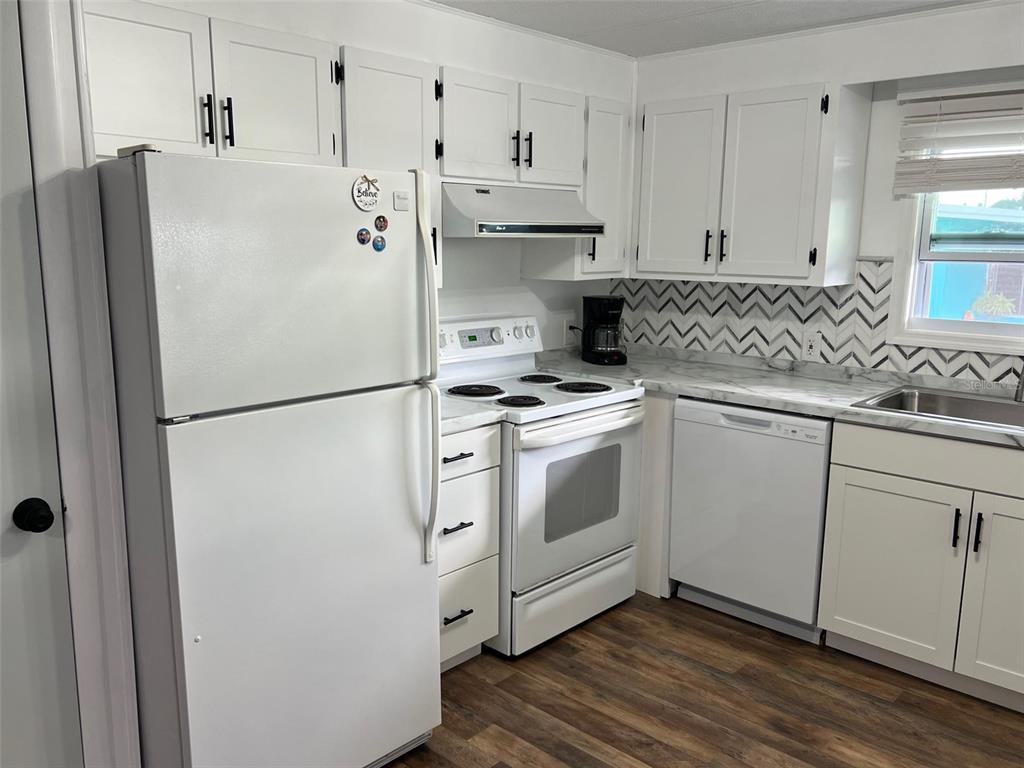 576 Queen Palm Largo, FL 33778 - Photo 5 of 33 a white refrigerator freezer sitting inside of a kitchen