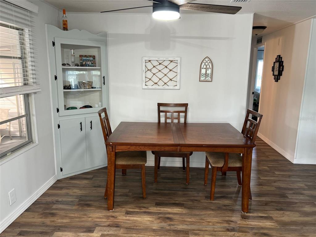 576 Queen Palm Largo, FL 33778 - Photo 8 of 33 a view of a dining room with furniture wooden floor and a window