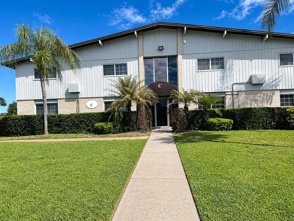 1695 Lee Road, Unit C206 Winter Park, FL 32789 - Photo 1 of 18 a front view of a house with a yard
