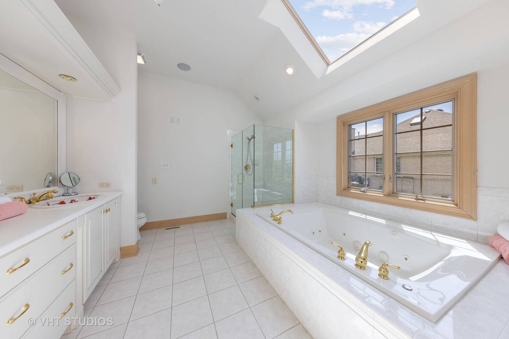 101 Windmill Road Orland Park, IL 60467 - Photo 27 of 56 a bathroom with a tub a double vanity sink a window and a bathtub