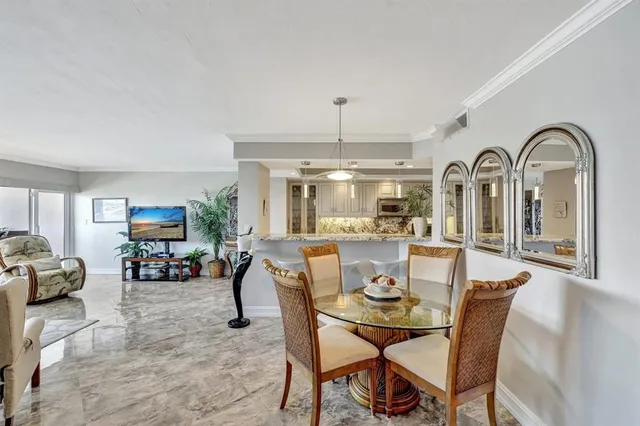 a dining room with furniture a chandelier and window