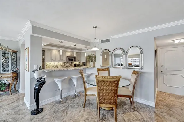 a living room with furniture a chandelier and a dining table