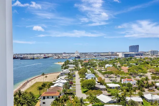 a bedroom with a bed a flat screen tv and a large window