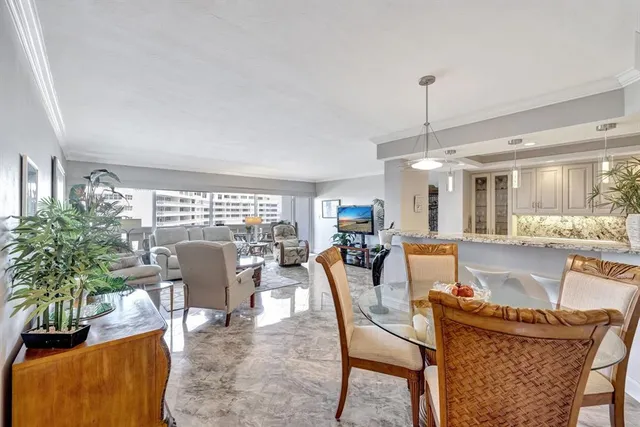 a dining room with furniture a chandelier and wooden floor