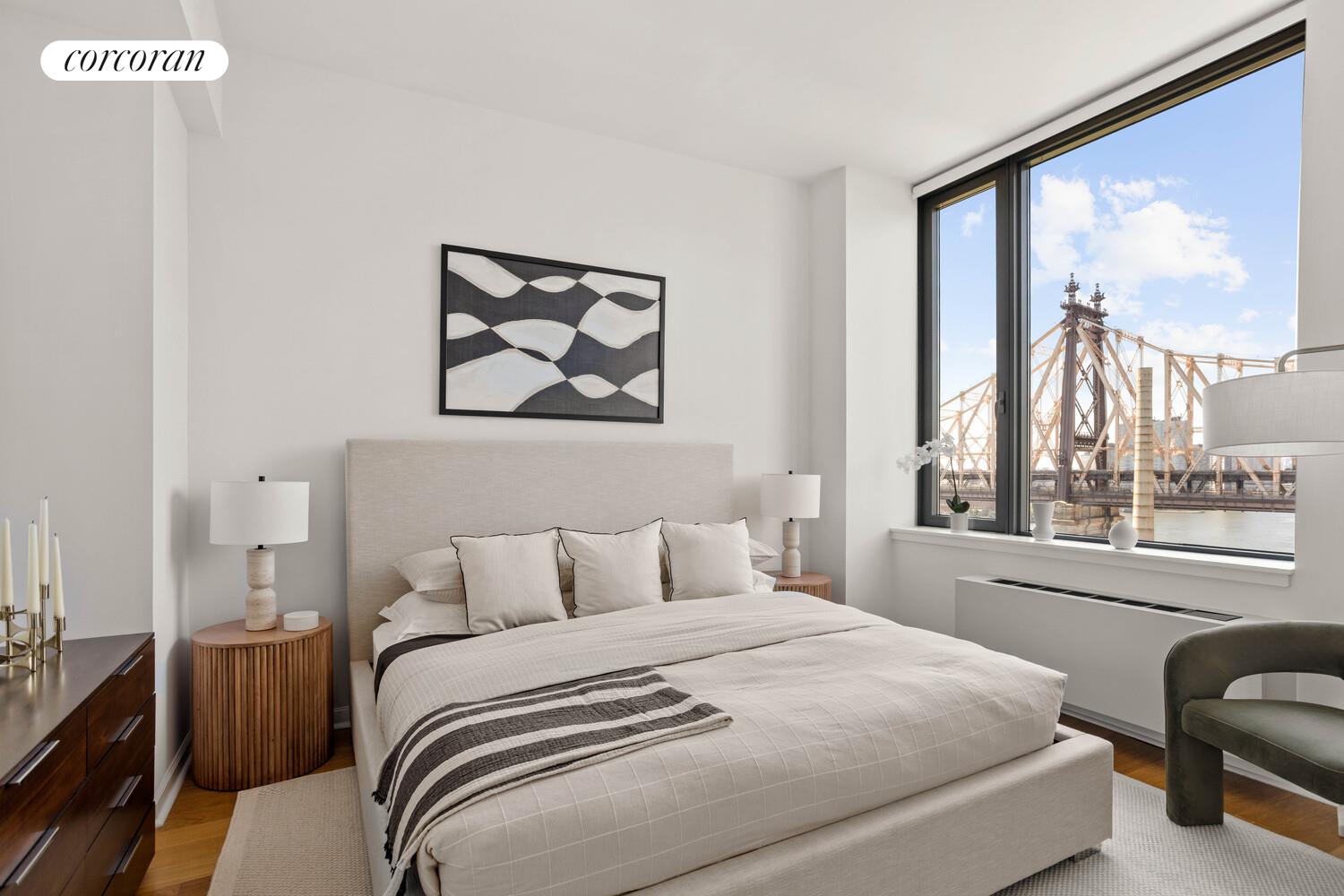 425 Main Street, Unit PH2E Manhattan, NY 10044 - Photo 3 of 22 a bedroom with a bed and a large window