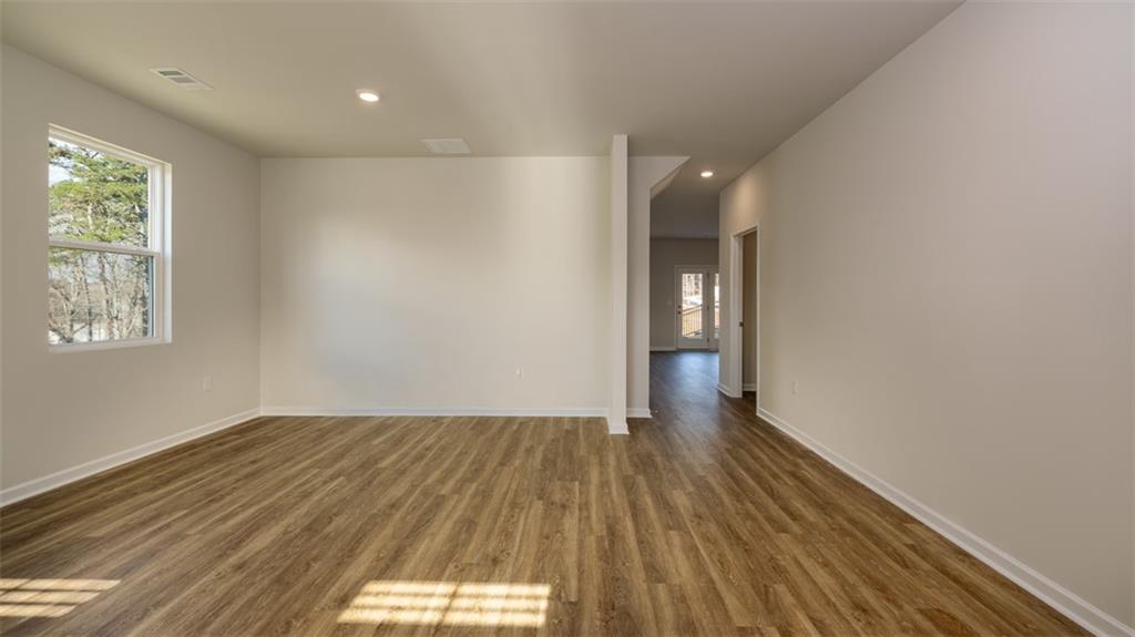 2262 Edgecombe Lane Dacula, GA 30019 - Photo 11 of 41 a view of an empty room with wooden floor and a window
