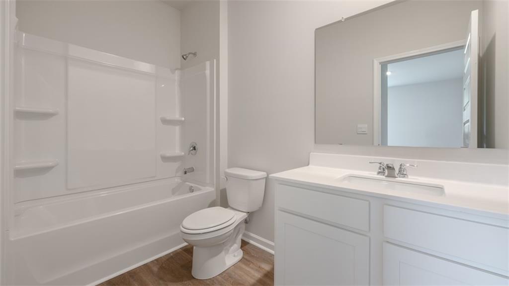 2262 Edgecombe Lane Dacula, GA 30019 - Photo 39 of 41 a bathroom with a toilet sink vanity tub and shower