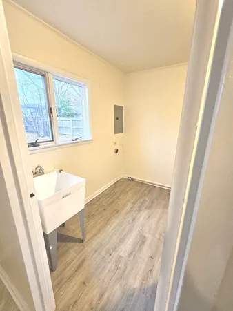 view of a room with wooden floor and front door