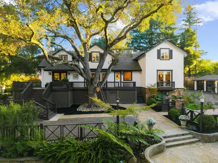 a front view of a house with a garden