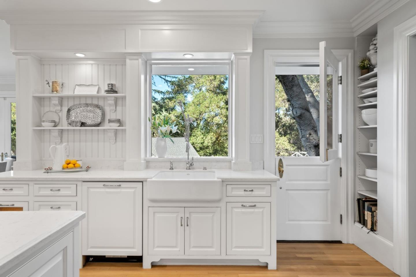 19050 Camino Barco Saratoga, CA 95070 - Photo 17 of 91 a kitchen with white cabinets and wooden floors