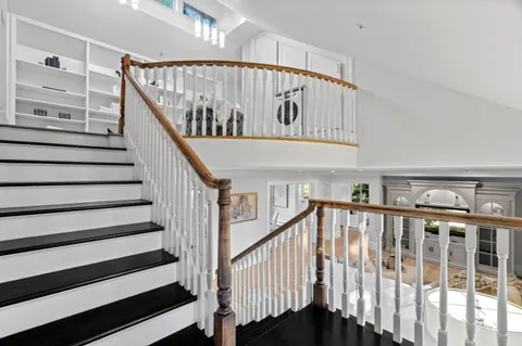 a living room with furniture a clock and a window