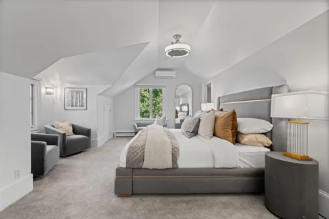 a living room with furniture and kitchen view