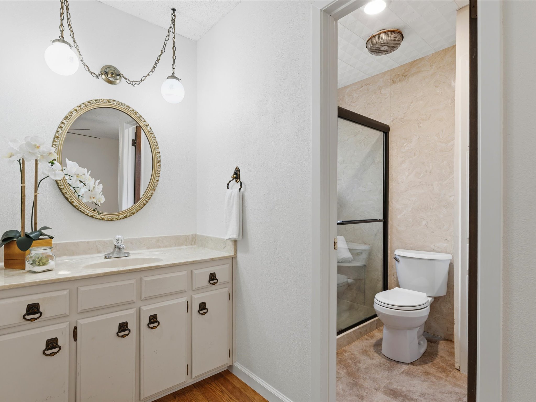 1005 Ranch Road Georgetown, TX 78628 - Photo 18 of 30 The in room vanity offers classic retro appeal with the original light fixture and cabinetry.