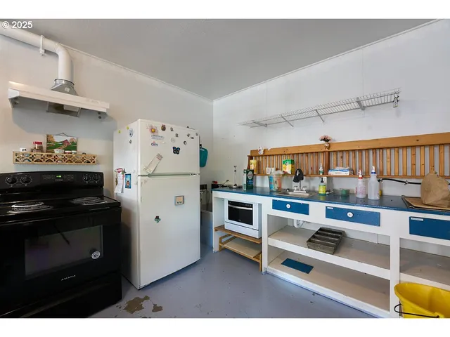 a kitchen with stainless steel appliances kitchen island granite countertop a refrigerator and a stove