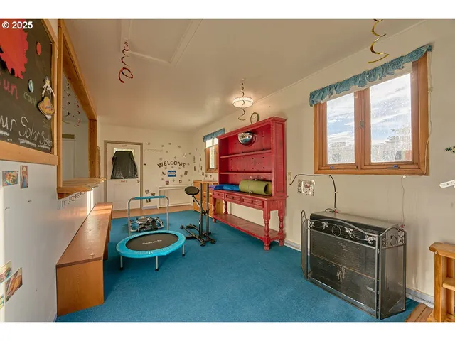 a living room with furniture a flat screen tv and a stove