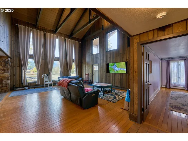 a living room with furniture and large windows