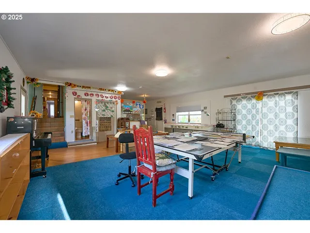a living room with furniture pool table and a large window