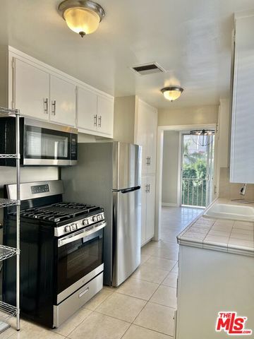 a kitchen with a stove and a refrigerator