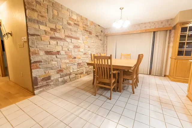 a kitchen with stainless steel appliances kitchen island granite countertop a refrigerator a stove and a sink