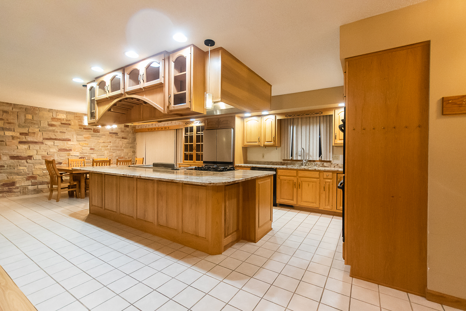 1245 Highway 26 Dixon, IL 61021 - Photo 17 of 40 a kitchen with stainless steel appliances kitchen island granite countertop a refrigerator a stove and a sink
