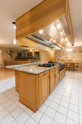 a kitchen with stainless steel appliances a stove a sink and a wooden floors