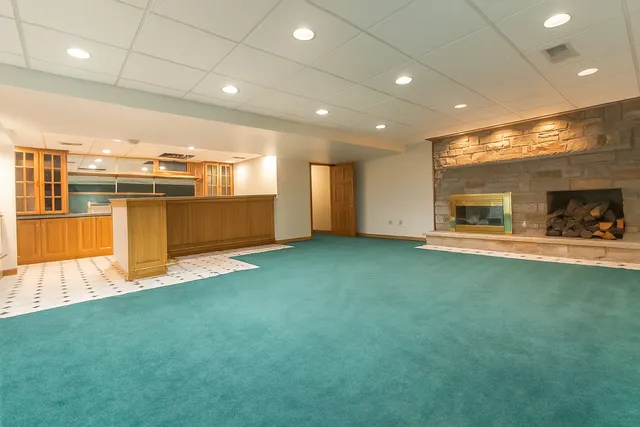 a view of an empty room with wooden floor and windows