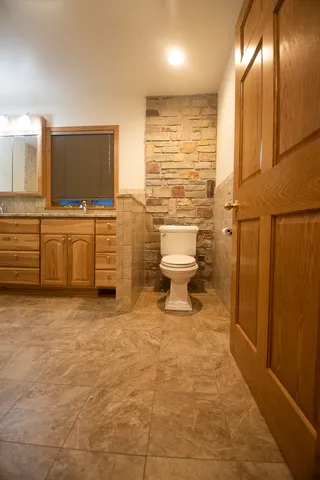 a spacious bathroom with a granite countertop sink and a mirror