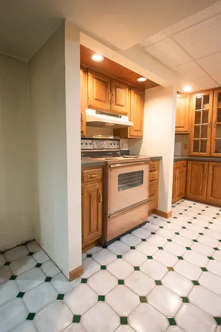 a view of a green field with some trees in the background