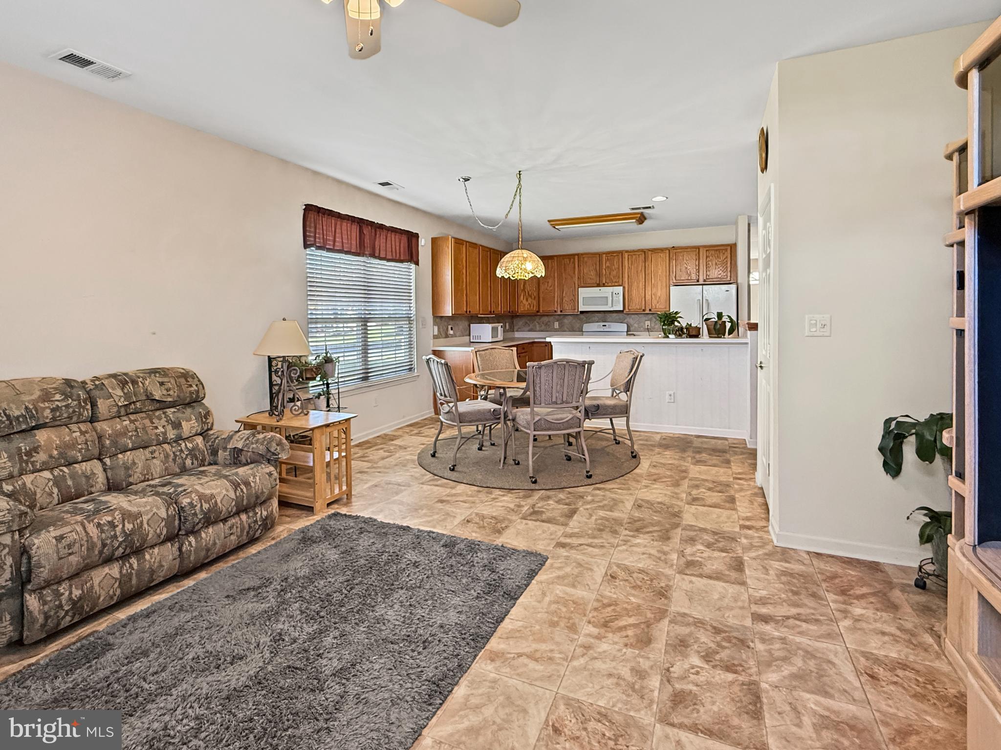49 Chamber Lane Columbus, NJ 08022 - Photo 4 of 48 a living room with furniture and a dining table with kitchen view