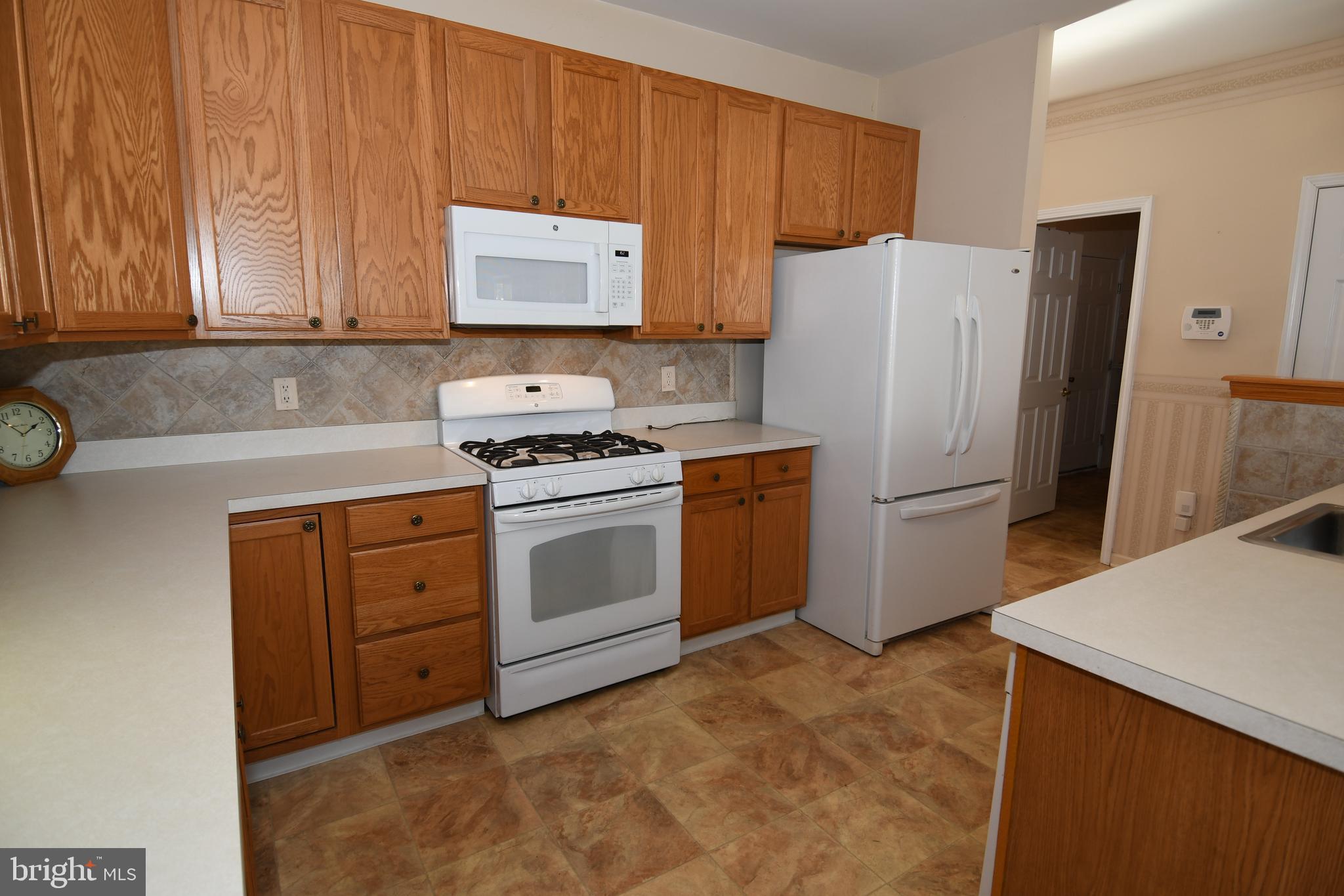 49 Chamber Lane Columbus, NJ 08022 - Photo 41 of 48 a kitchen with cabinets and white appliances