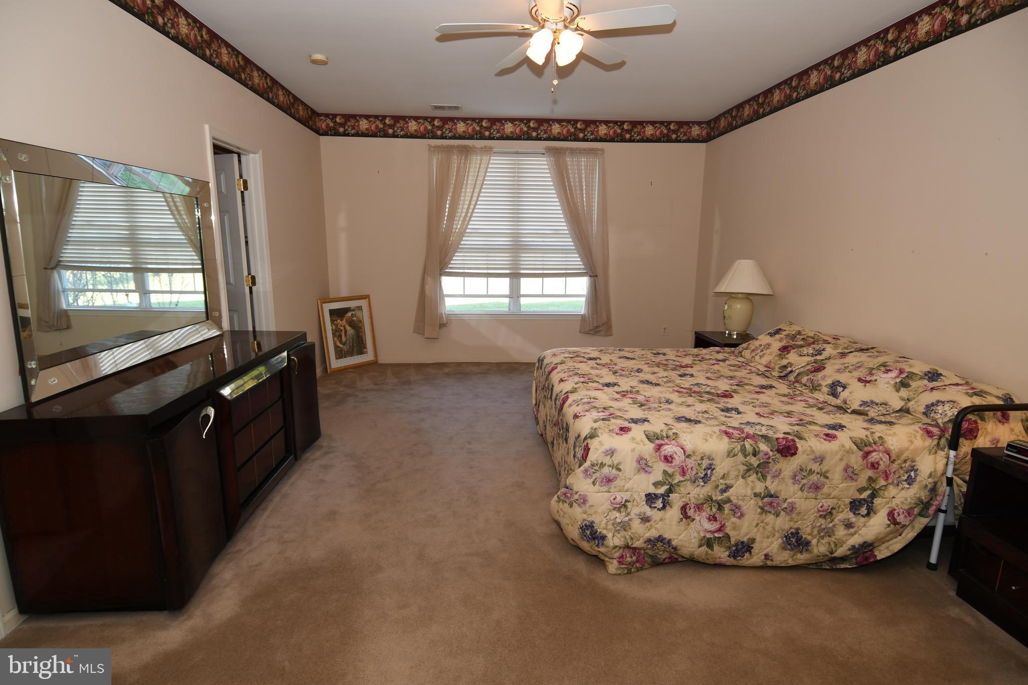 49 Chamber Lane Columbus, NJ 08022 - Photo 44 of 48 a bedroom with a bed and a flat tv screen on dresser
