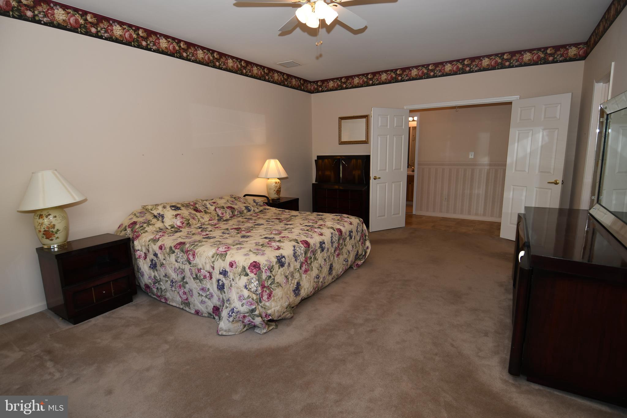 49 Chamber Lane Columbus, NJ 08022 - Photo 47 of 48 a bedroom with a bed and a chandelier