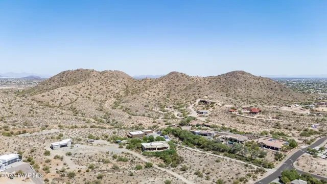 an aerial view of residential house and mountains in the background