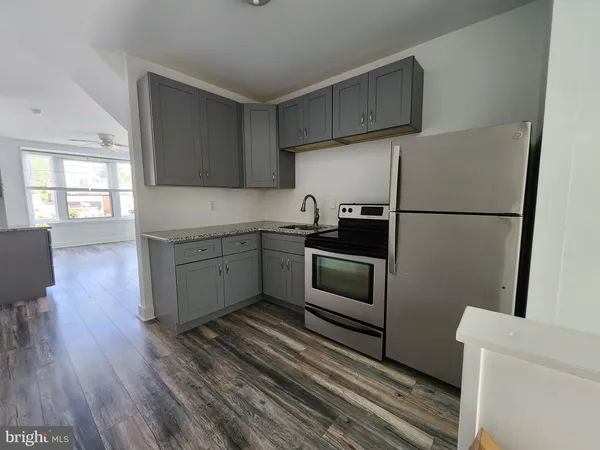 a kitchen with a refrigerator sink and cabinets