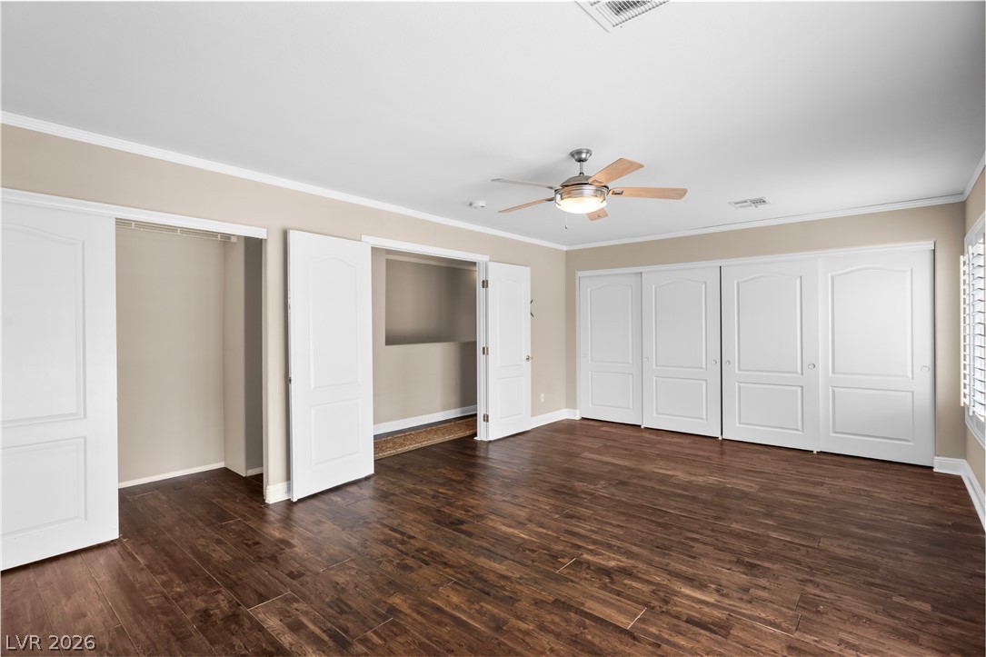 708 Vortex Avenue Henderson, NV 89002 - Photo 28 of 71 Rich hardwood-style flooring extends across this spacious, naturally illuminated room, complemented by a contemporary ceiling fan.