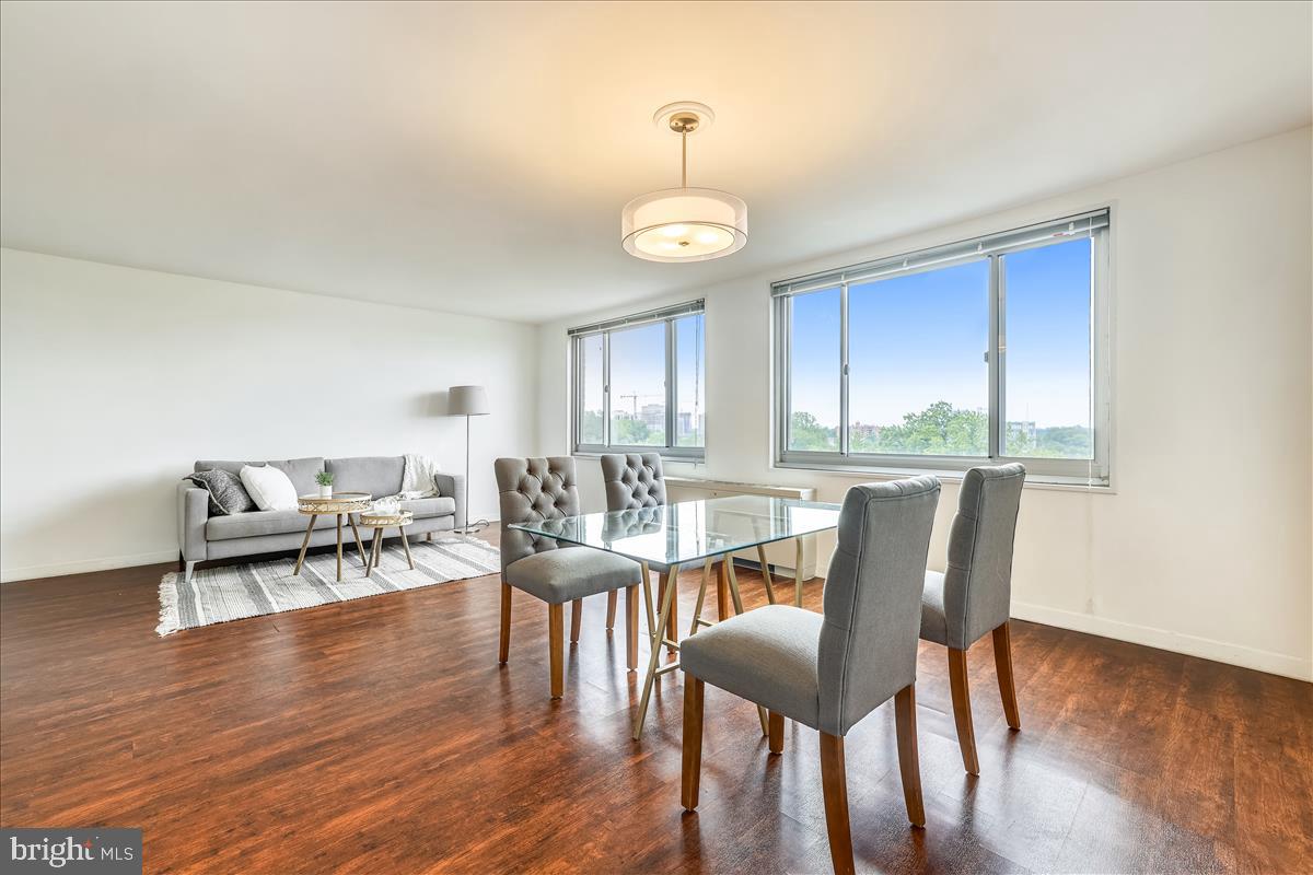 1900 Lyttonsville Road, Unit 1308 Silver Spring, MD 20910 - Photo 1 of 30 a view of a dining room with furniture window and wooden floor