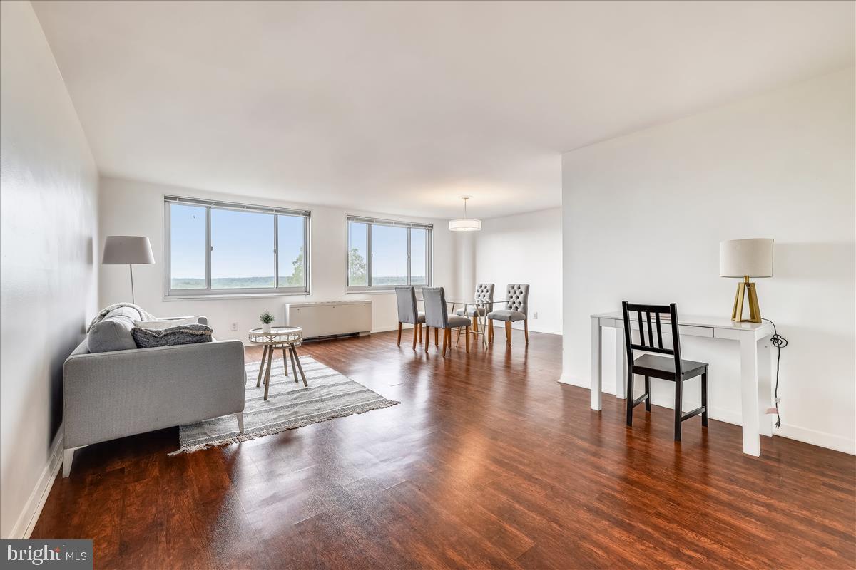 1900 Lyttonsville Road, Unit 1308 Silver Spring, MD 20910 - Photo 2 of 30 a living room with furniture wooden floor and a table
