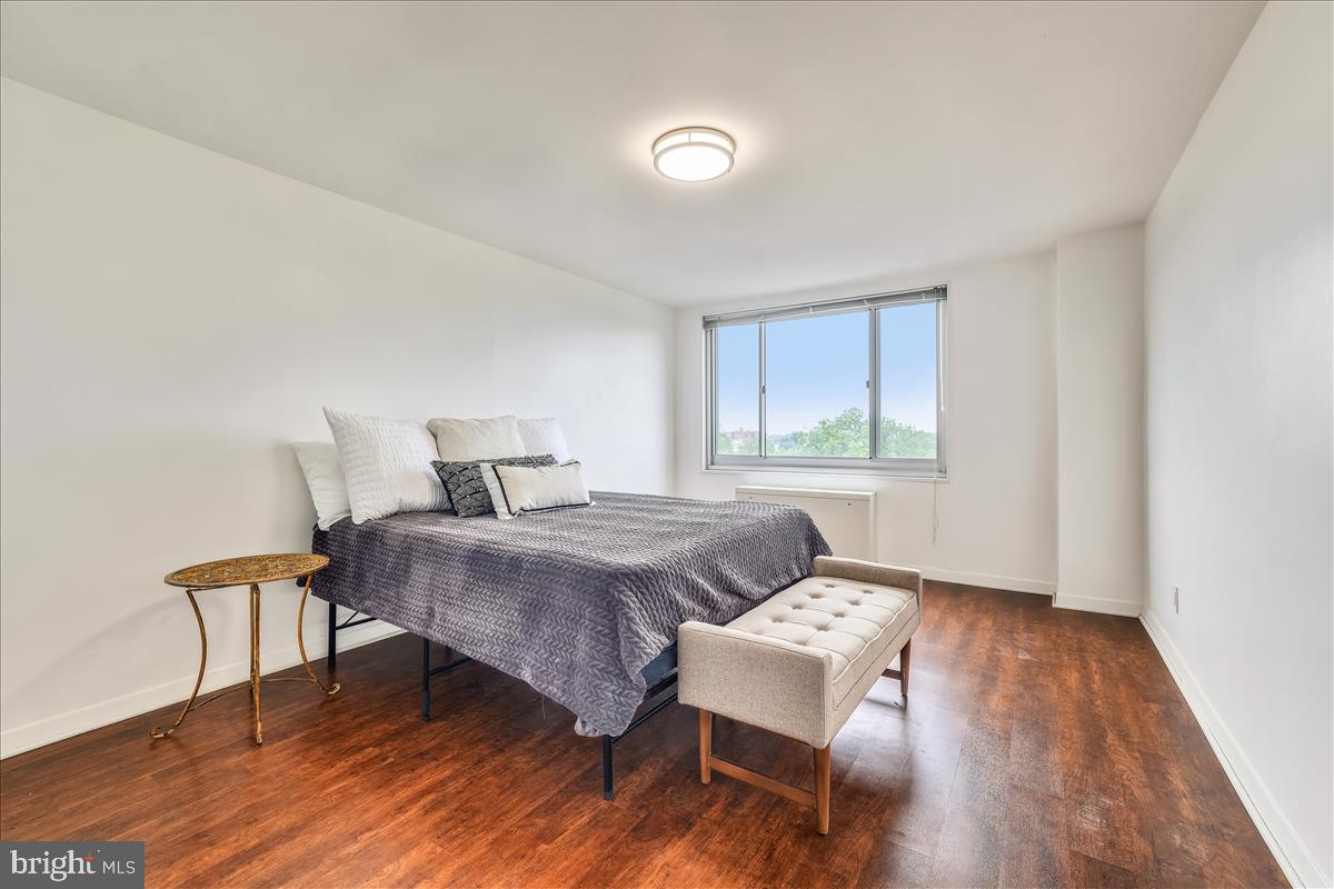 1900 Lyttonsville Road, Unit 1308 Silver Spring, MD 20910 - Photo 12 of 30 a bedroom with a bed and wooden floor