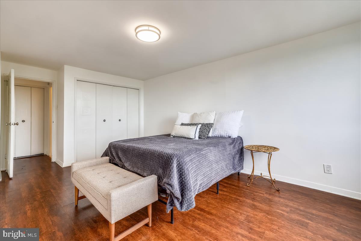1900 Lyttonsville Road, Unit 1308 Silver Spring, MD 20910 - Photo 13 of 30 a bedroom with a bed and wooden floor